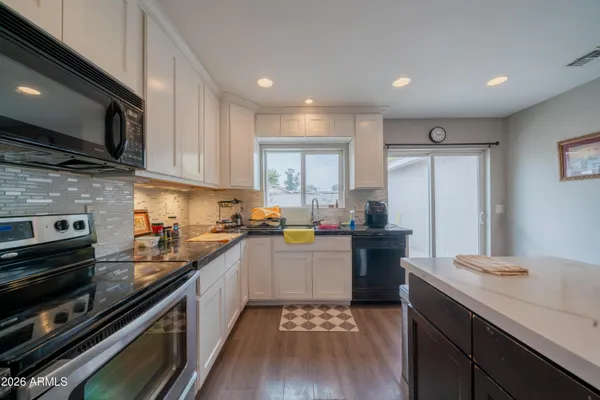a kitchen with a sink cabinets and stainless steel appliances