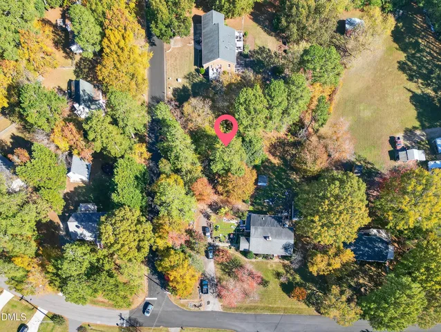 an aerial view of house with yard and parking space