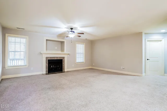 a kitchen with stainless steel appliances granite countertop a refrigerator a stove and a sink with wooden floor