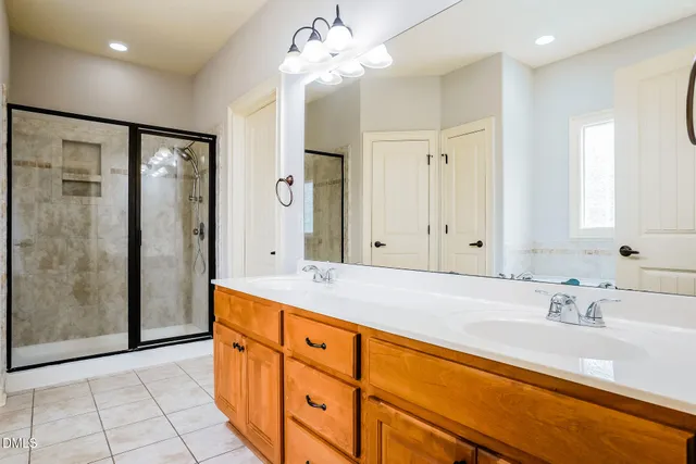 a bathroom with a tub sink and mirror