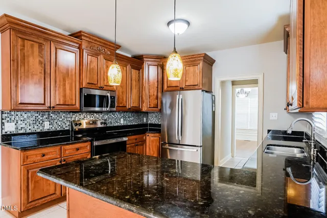 a kitchen with a refrigerator and a sink