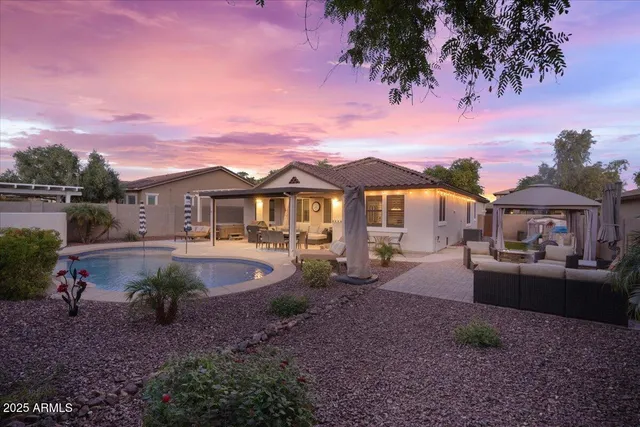 a view of a house with backyard sitting area and garden