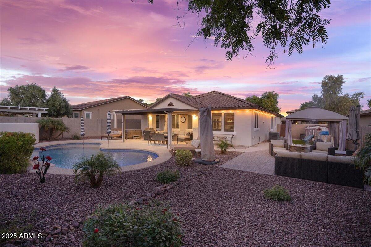 a view of a house with backyard sitting area and garden