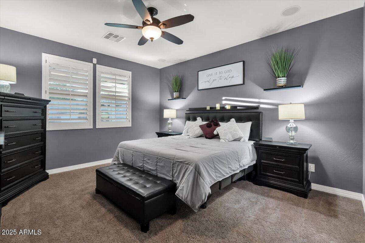 3214 North Springfield Street Buckeye, AZ 85396 - Photo 16 of 64 a bedroom with a bed dresser and a window