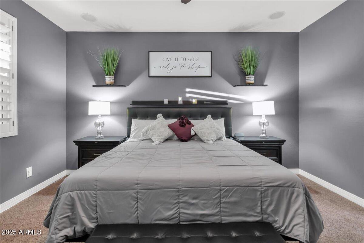 3214 North Springfield Street Buckeye, AZ 85396 - Photo 17 of 64 a bedroom with a bed and a painting on the wall