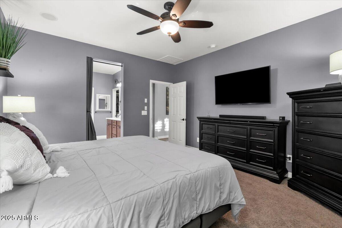 3214 North Springfield Street Buckeye, AZ 85396 - Photo 18 of 64 a bedroom with a bed and a flat screen tv