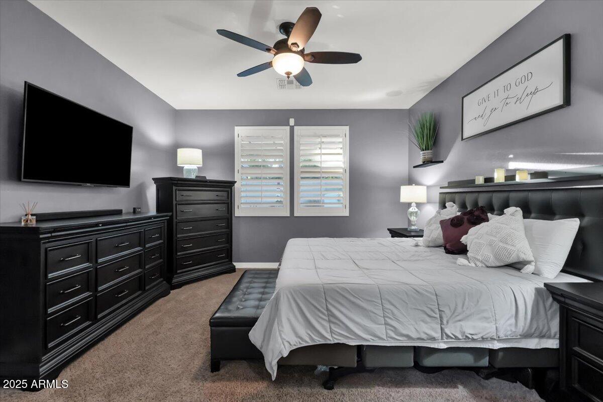 3214 North Springfield Street Buckeye, AZ 85396 - Photo 19 of 64 a bedroom with a bed and a flat screen tv