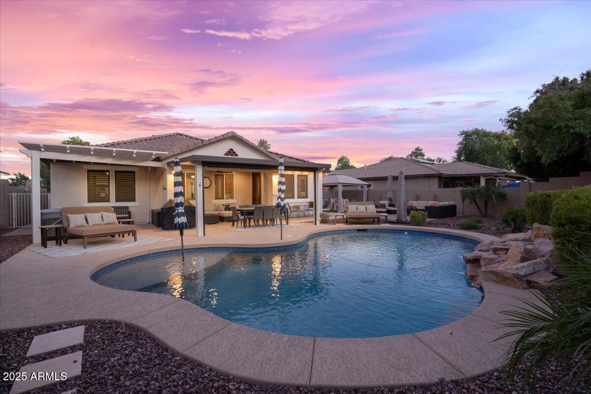 3214 North Springfield Street Buckeye, AZ 85396 - Photo 2 of 64 a view of a house with swimming pool and sitting area