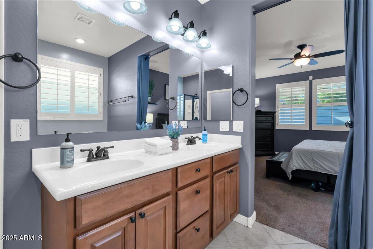 3214 North Springfield Street Buckeye, AZ 85396 - Photo 24 of 64 a bathroom with a sink double vanity and a mirror