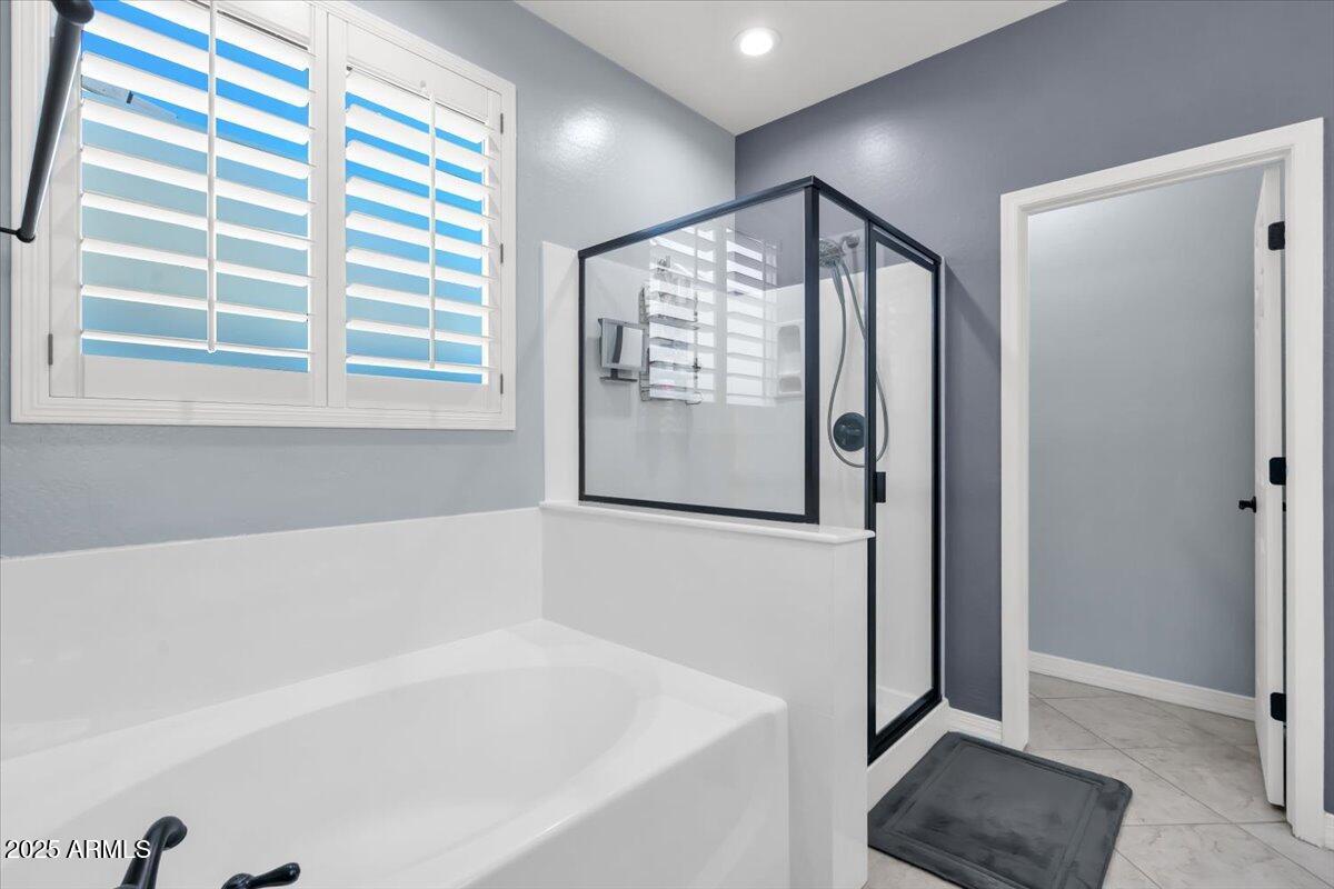 3214 North Springfield Street Buckeye, AZ 85396 - Photo 25 of 64 a bathroom with a bathtub and a shower