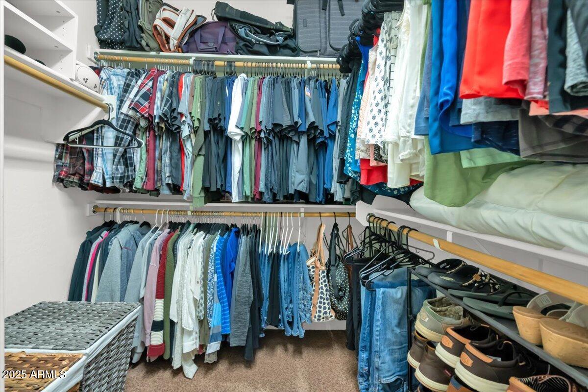 3214 North Springfield Street Buckeye, AZ 85396 - Photo 26 of 64 a view of walk in closet with clothes