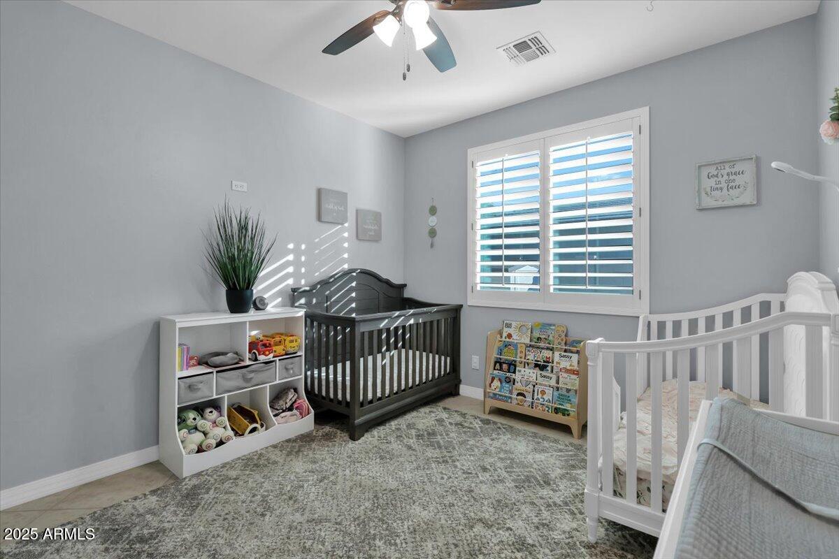 3214 North Springfield Street Buckeye, AZ 85396 - Photo 29 of 64 a bedroom with furniture and a window