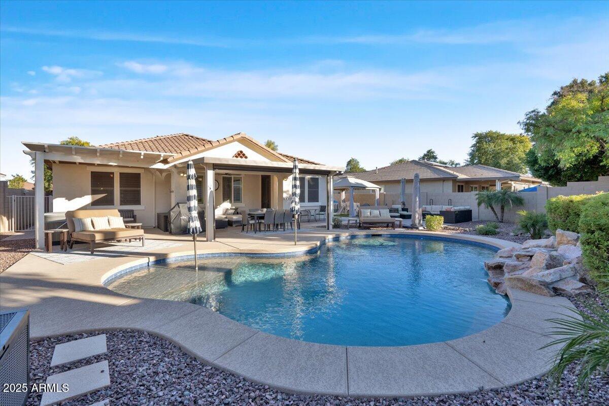 3214 North Springfield Street Buckeye, AZ 85396 - Photo 32 of 64 a view of a house with swimming pool and sitting area