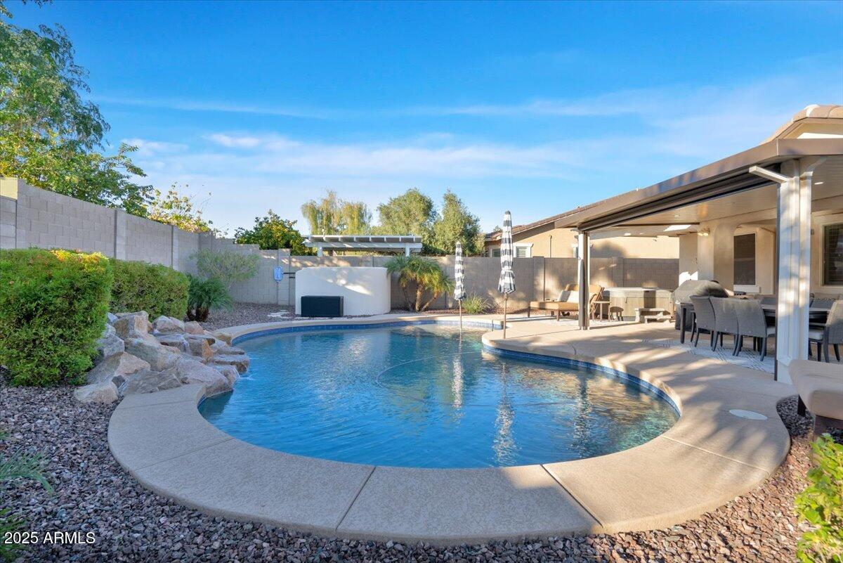 3214 North Springfield Street Buckeye, AZ 85396 - Photo 35 of 64 a view of a swimming pool with sitting area