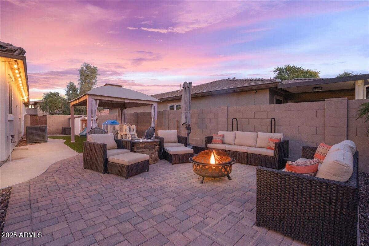 3214 North Springfield Street Buckeye, AZ 85396 - Photo 45 of 64 a backyard of a house with fire pit and furniture