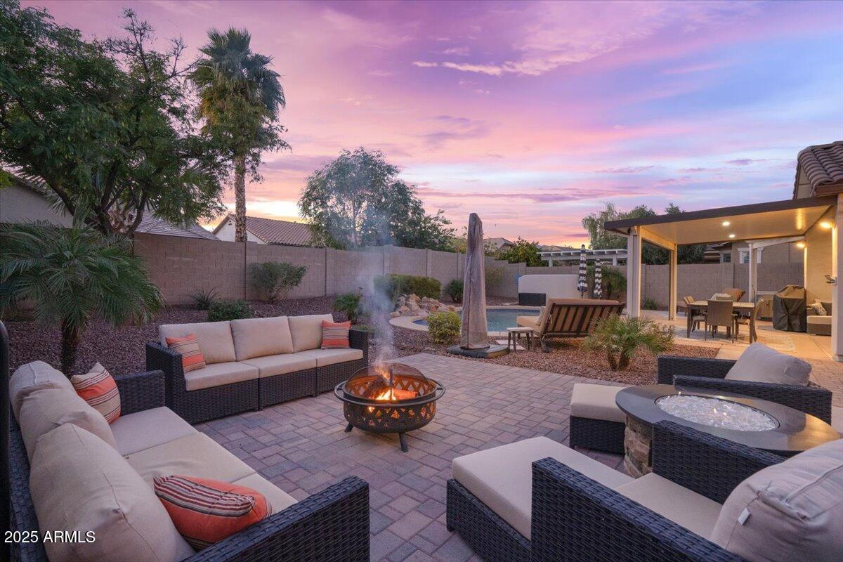 3214 North Springfield Street Buckeye, AZ 85396 - Photo 46 of 64 a view of a patio with couches and a table and chairs with garden view