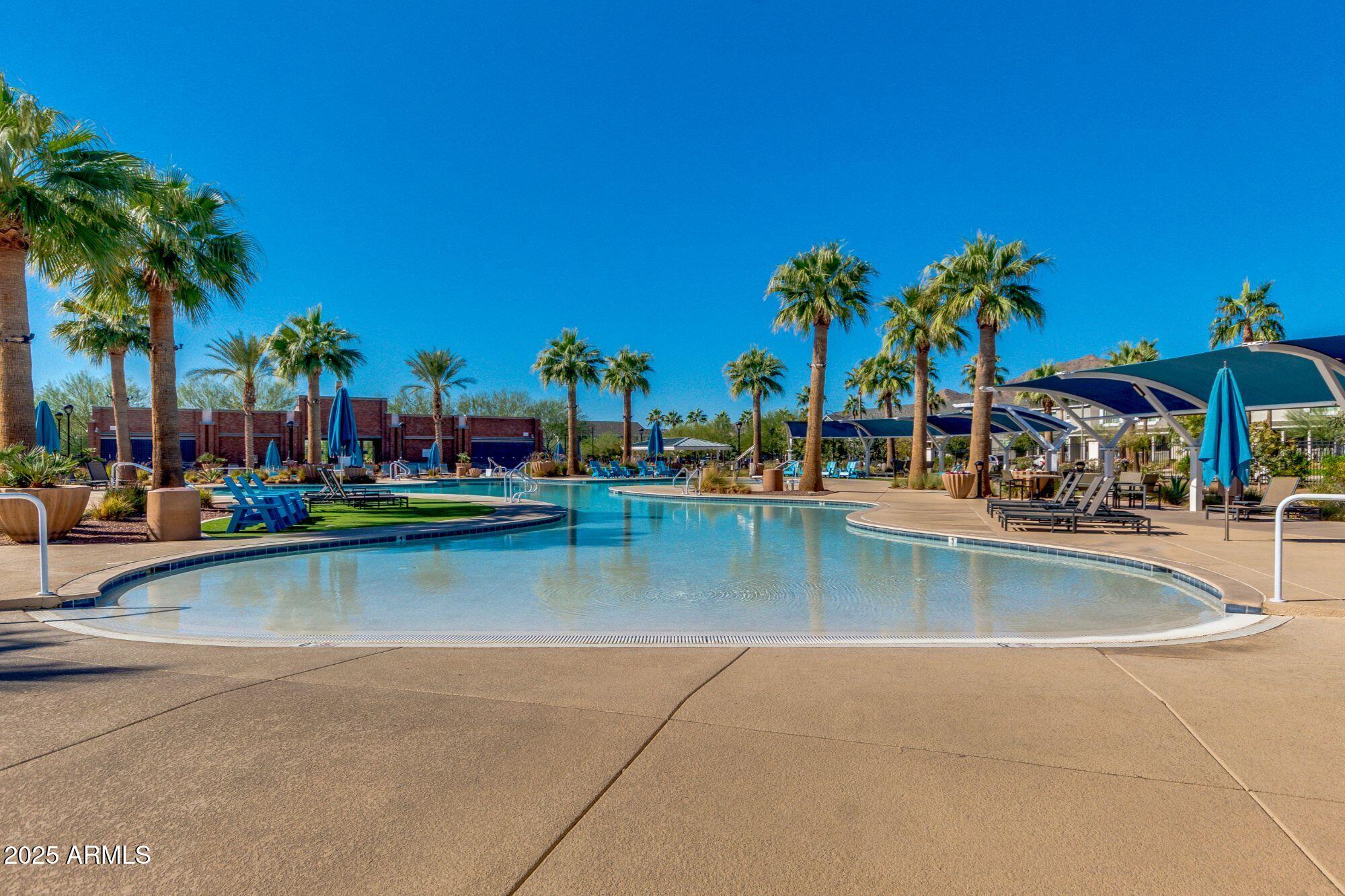 3214 North Springfield Street Buckeye, AZ 85396 - Photo 61 of 64 a view of swimming pool with outdoor seating and a palm tree