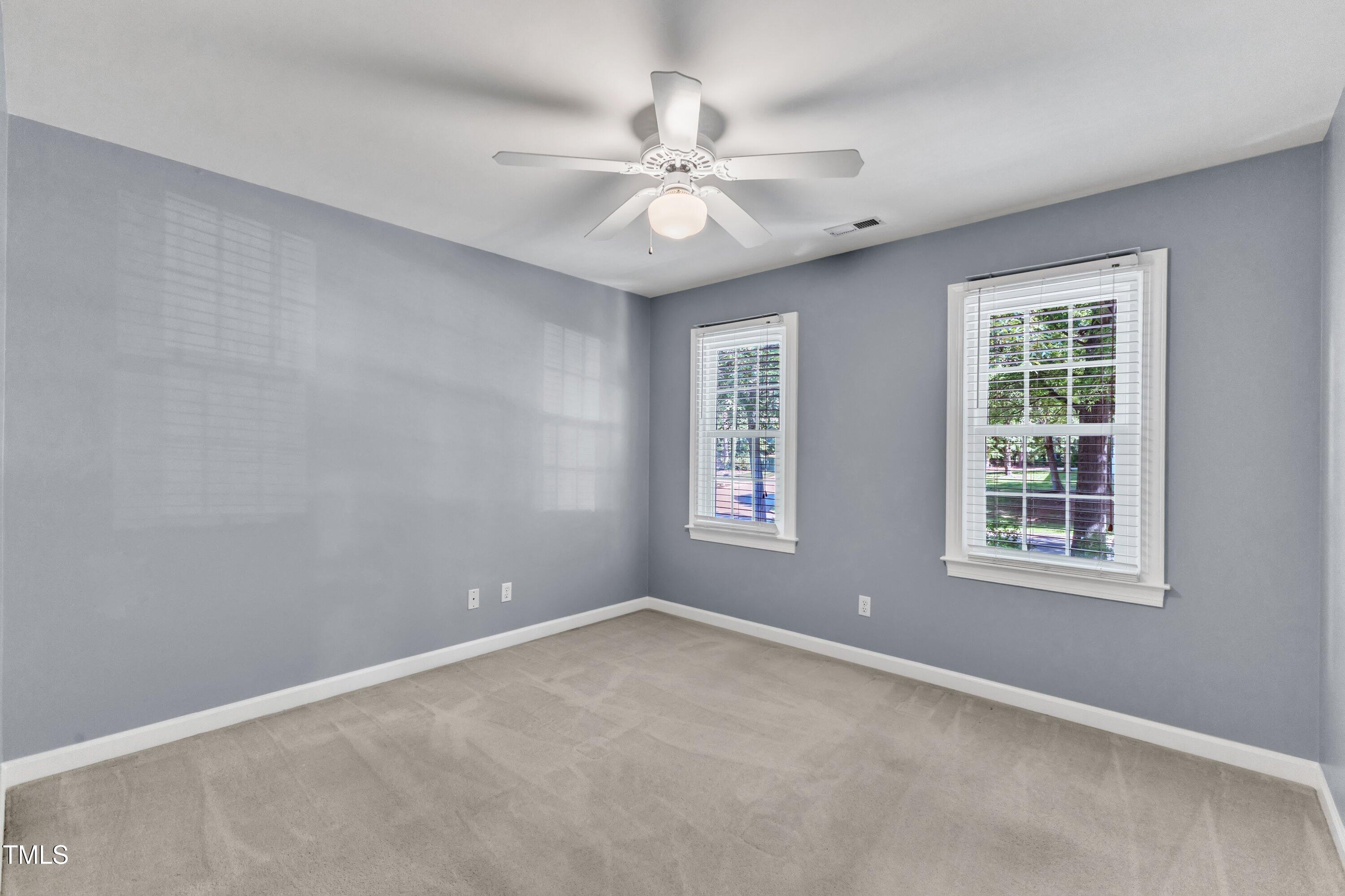 2125 Oakcrest Court Raleigh, NC 27612 - Photo 47 of 74 an empty room with a window and a fan