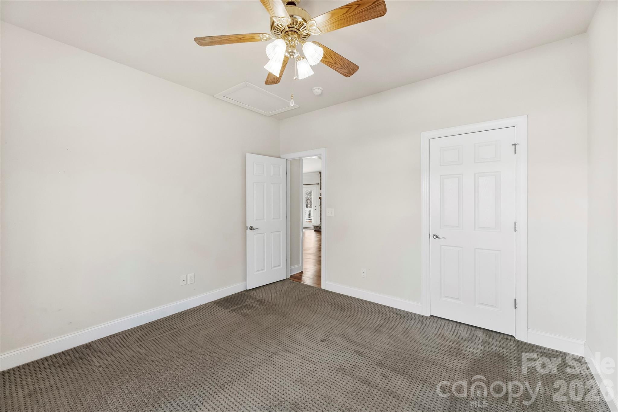 17858 Red Ridge Court Locust, NC 28097 - Photo 13 of 44 an empty room with a chandelier fan and windows