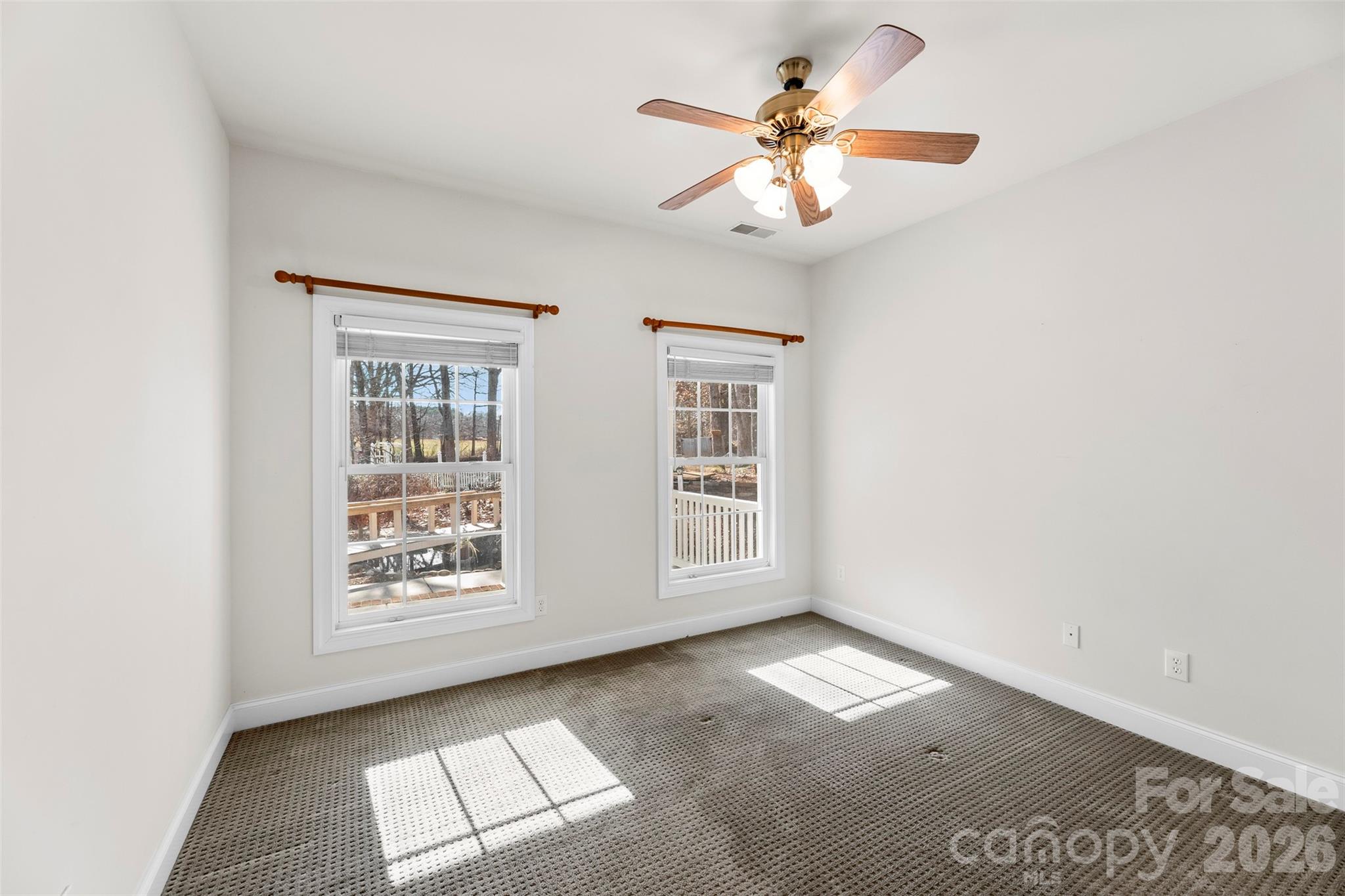 17858 Red Ridge Court Locust, NC 28097 - Photo 15 of 44 an empty room with windows and fan