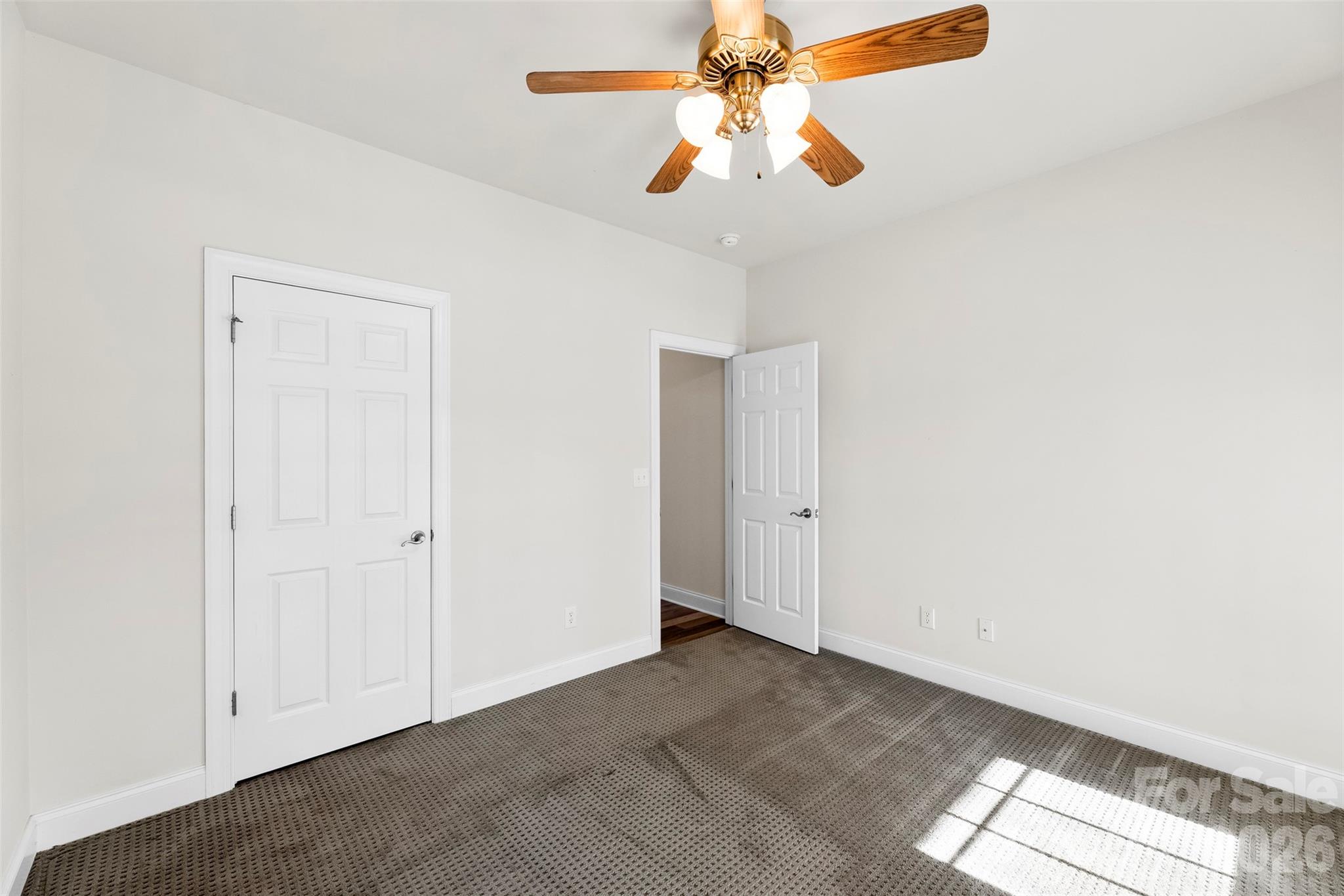 17858 Red Ridge Court Locust, NC 28097 - Photo 17 of 44 an empty room with closet and chandelier fan