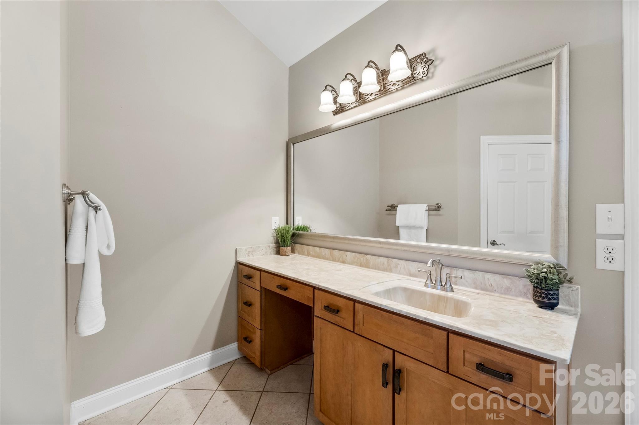 17858 Red Ridge Court Locust, NC 28097 - Photo 26 of 44 a bathroom with a sink vanity and a mirror