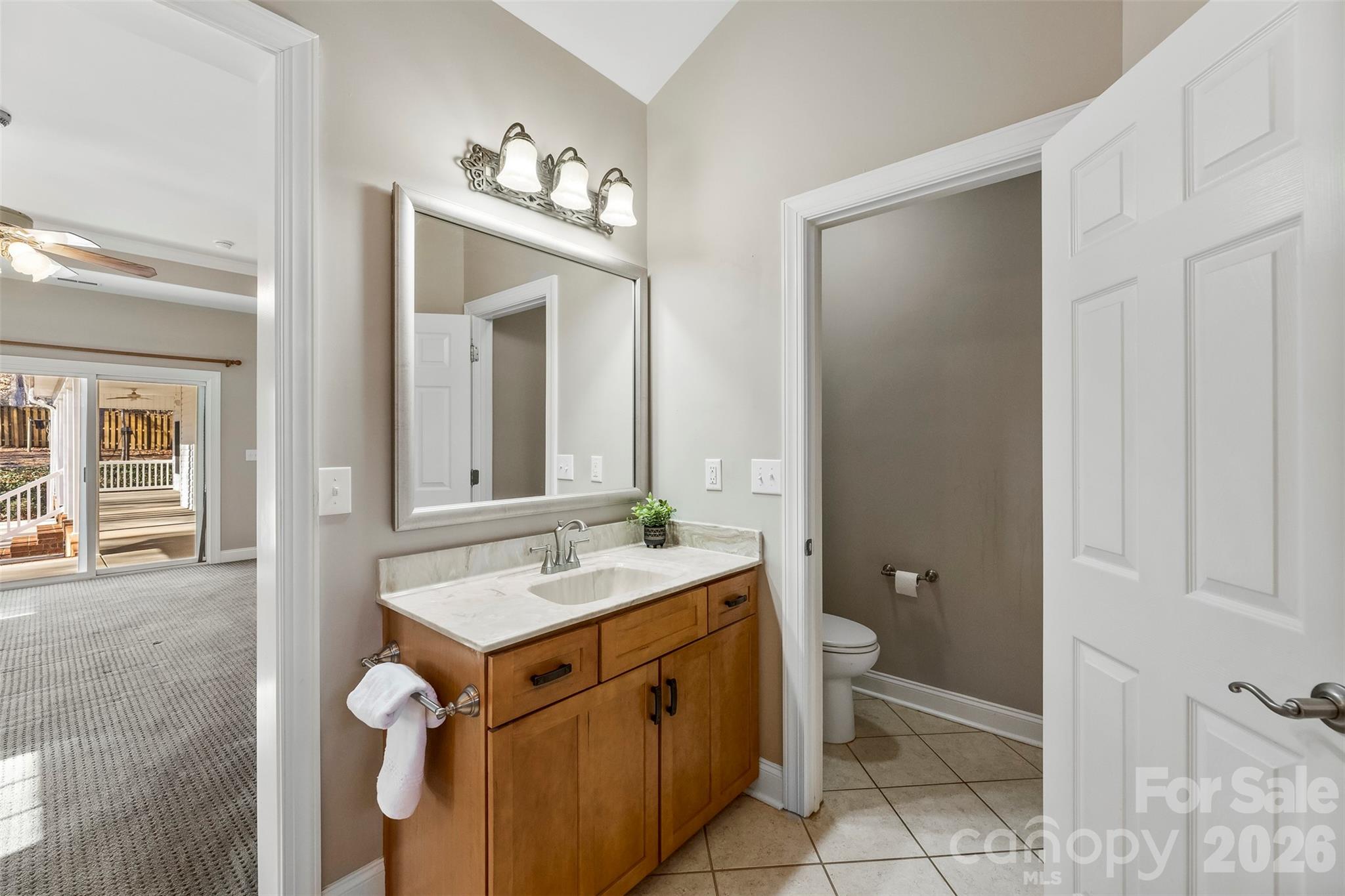 17858 Red Ridge Court Locust, NC 28097 - Photo 27 of 44 a bathroom with a sink toilet and mirror