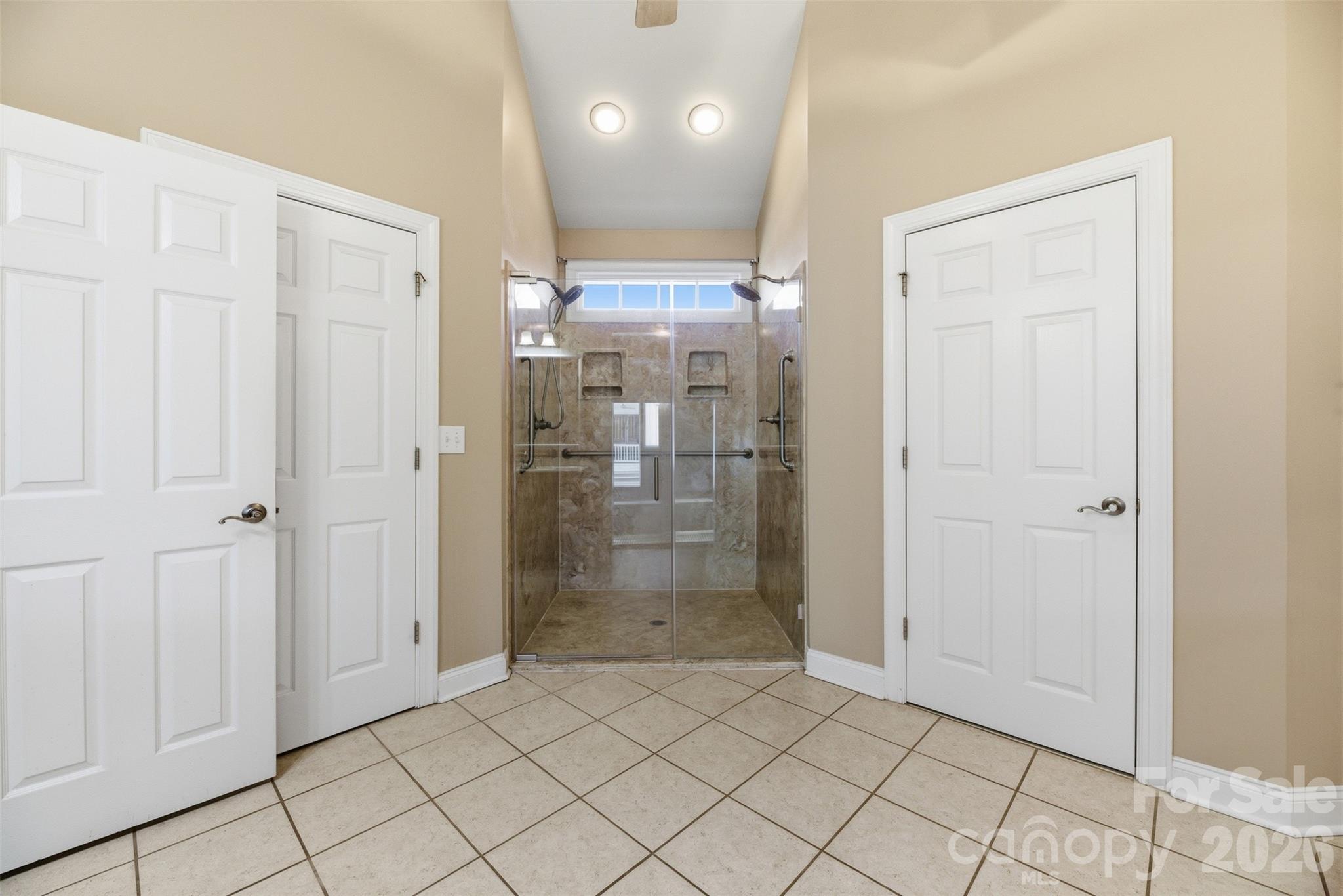 17858 Red Ridge Court Locust, NC 28097 - Photo 28 of 44 a bathroom with a shower and a glass door