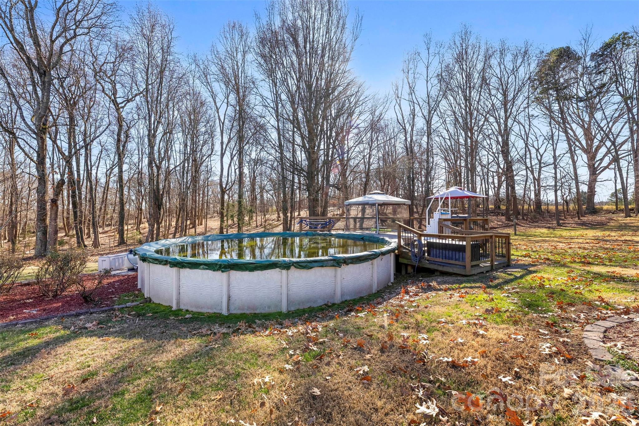 17858 Red Ridge Court Locust, NC 28097 - Photo 38 of 44 a view of a swimming pool with a backyard and seating