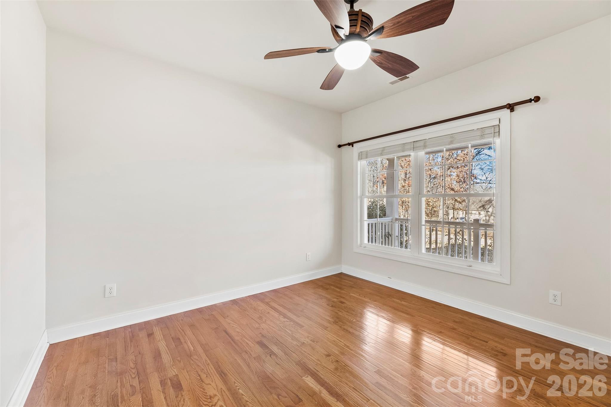 17858 Red Ridge Court Locust, NC 28097 - Photo 4 of 44 a view of an empty room with wooden floor and a window