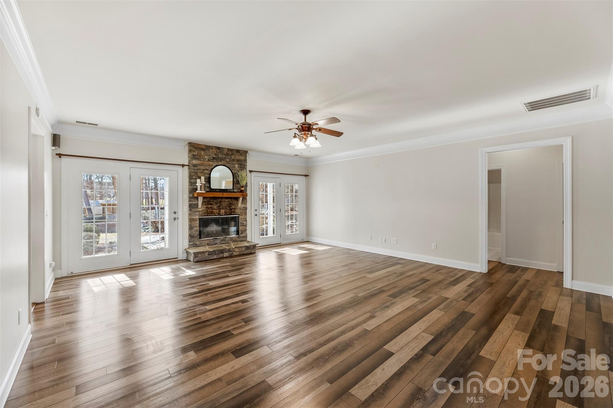 17858 Red Ridge Court Locust, NC 28097 - Photo 8 of 44 wooden floor in an empty room with a fireplace