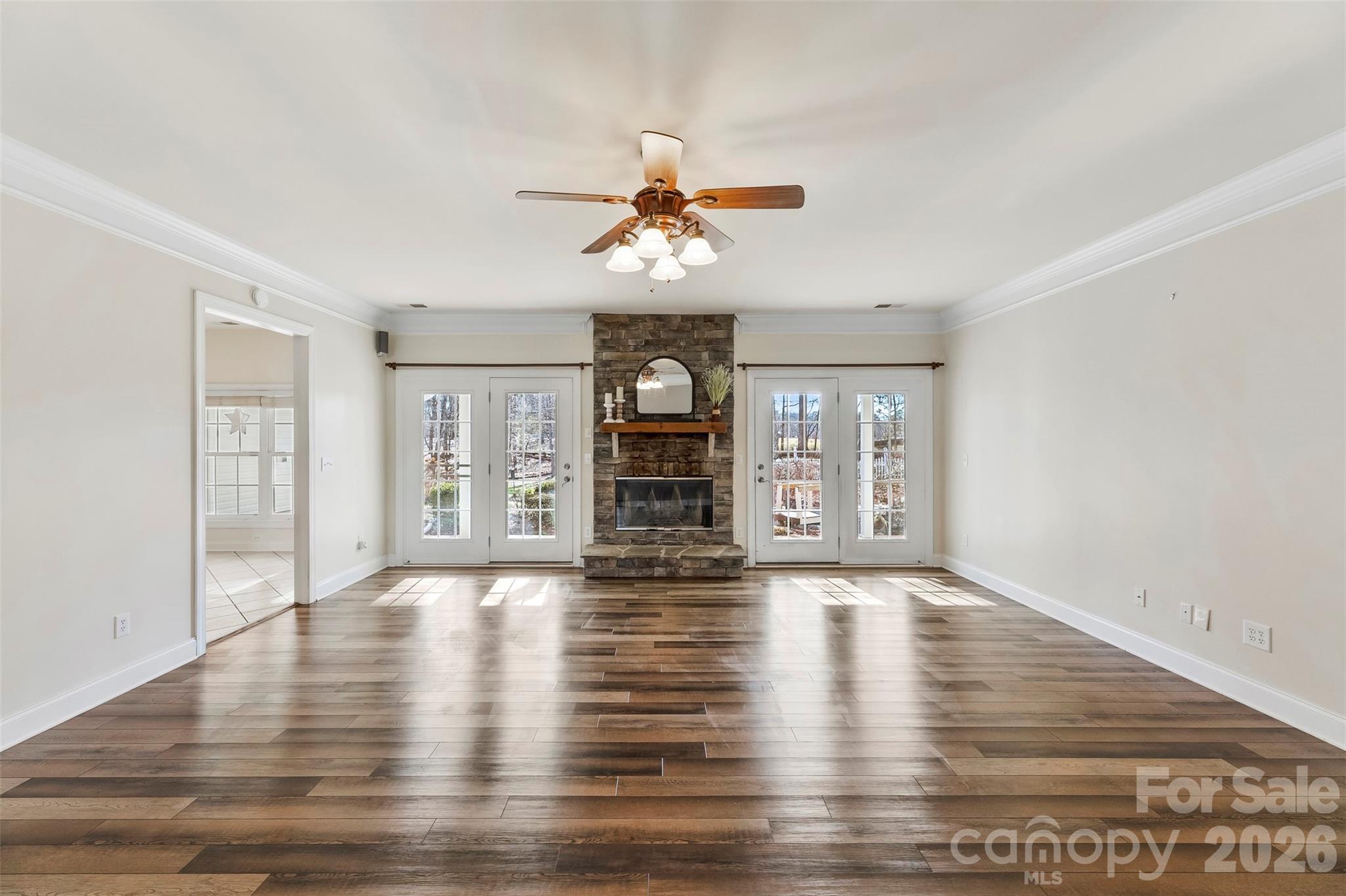 17858 Red Ridge Court Locust, NC 28097 - Photo 9 of 44 a view of an empty room with window and wooden floor