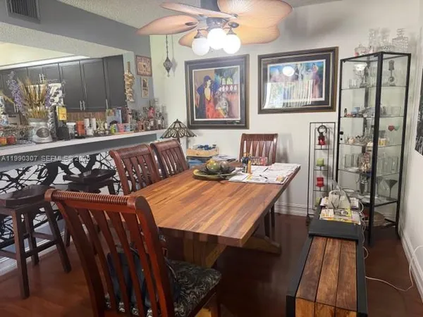 a living room with furniture a rug and a painting on the wall