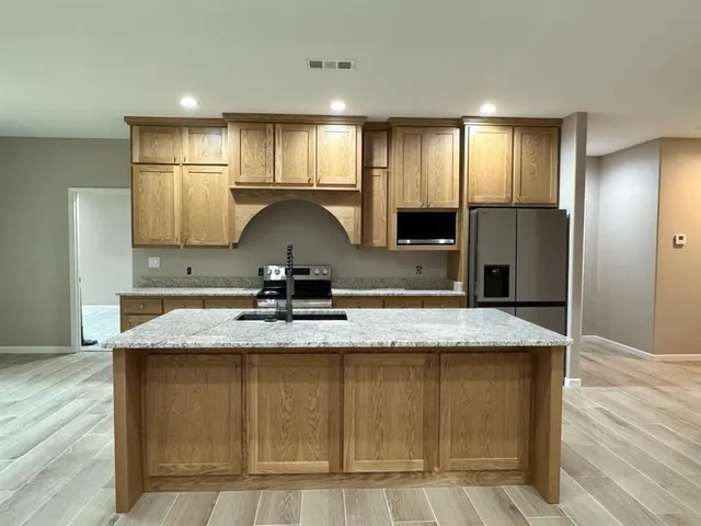 a view of a kitchen with a stove a sink and dishwasher