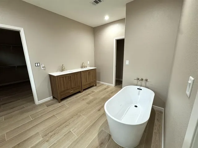 a spacious bathroom with a bathtub and shower