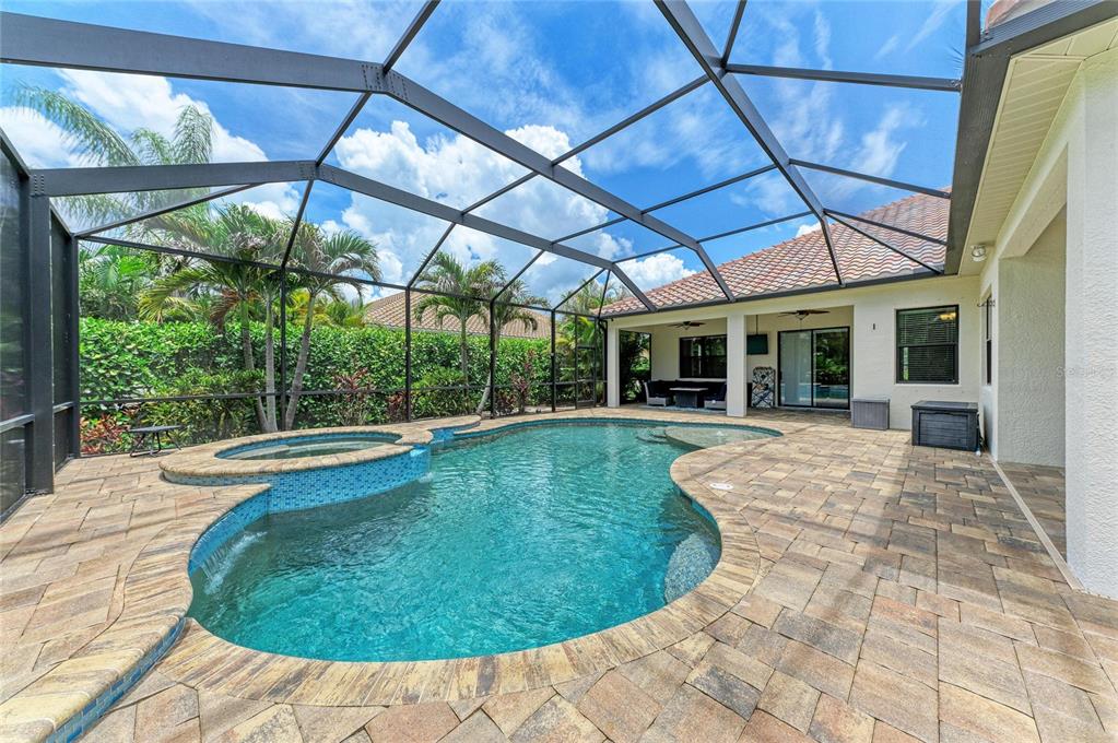 12642 Harney Street Venice, FL 34293 - Photo 50 of 85 a view of a swimming pool with a patio