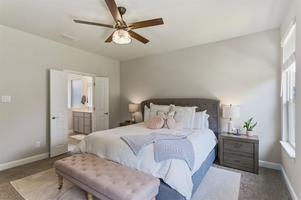 5621 Round Hl Road Denton, TX 76210 - Photo 17 of 27 a bedroom with a bed and a chandelier