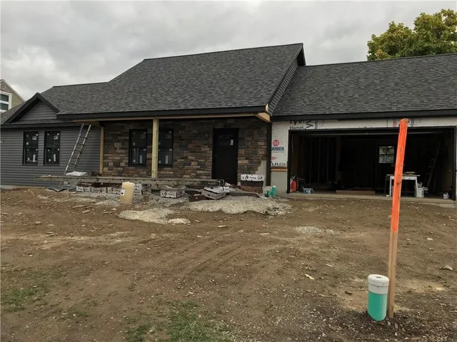 a view of an empty room with a fireplace and a large window
