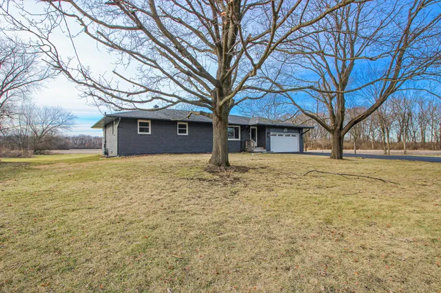 a large house with a large tree in front of it