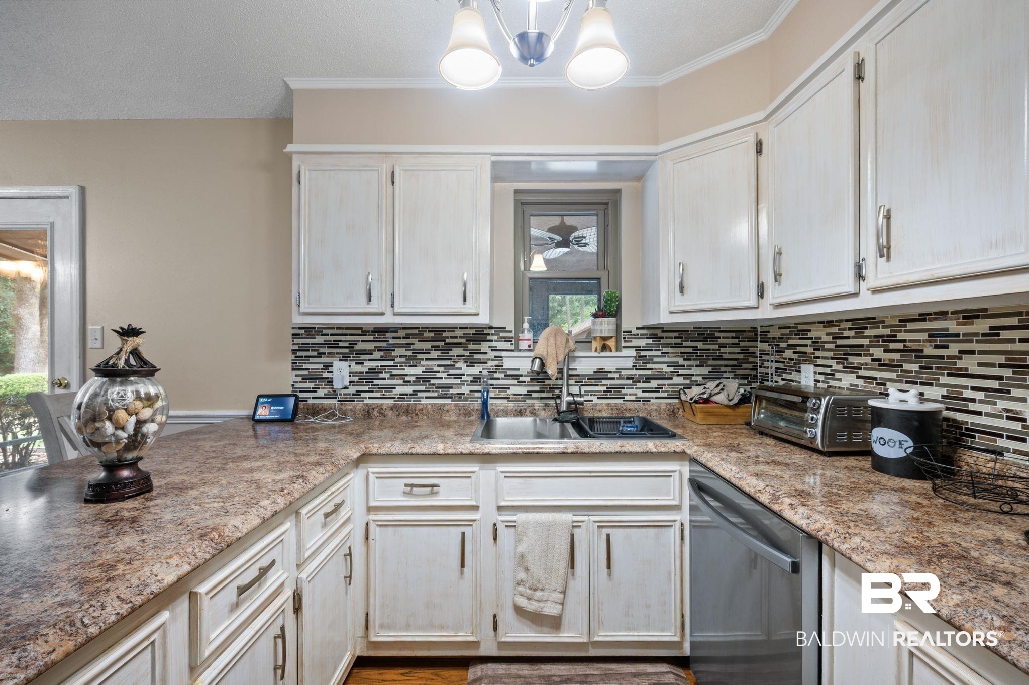 4566 McCrary Road, Unit A Semmes, AL 36575 - Photo 9 of 28 Kitchen with backsplash, dishwasher, a notable chandelier, sink, and pendant lighting