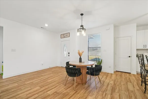 a view of a dining room with furniture and wooden floor