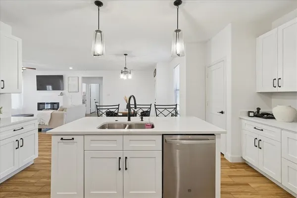 a kitchen with kitchen island a sink stainless steel appliances and cabinets