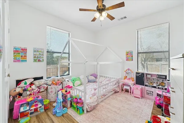 a bedroom with furniture and a baby crib