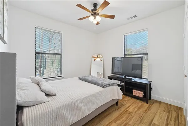 a bedroom with a bed and a flat screen tv