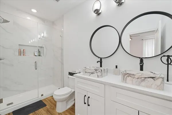 a bathroom with a toilet a sink and mirror