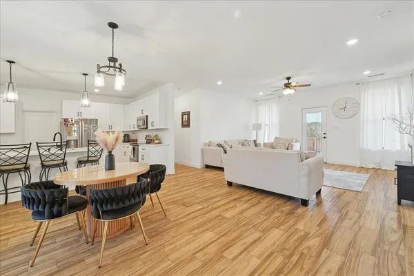a large kitchen with a table and chairs