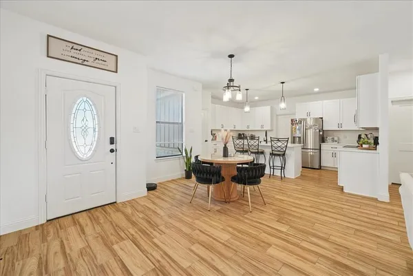 a view of a living room and kitchen with a wooden floor