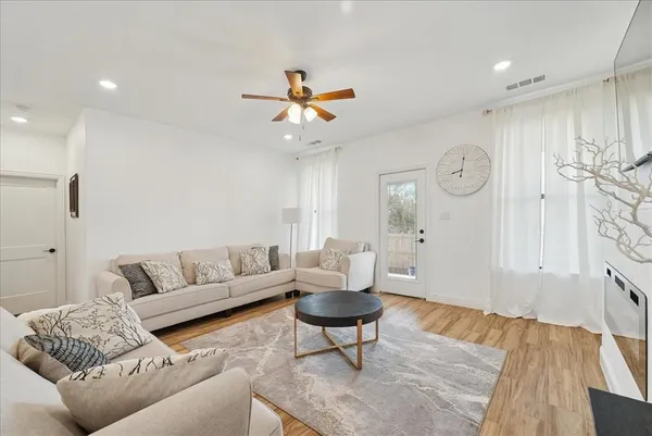 a living room with furniture a rug and a chandelier