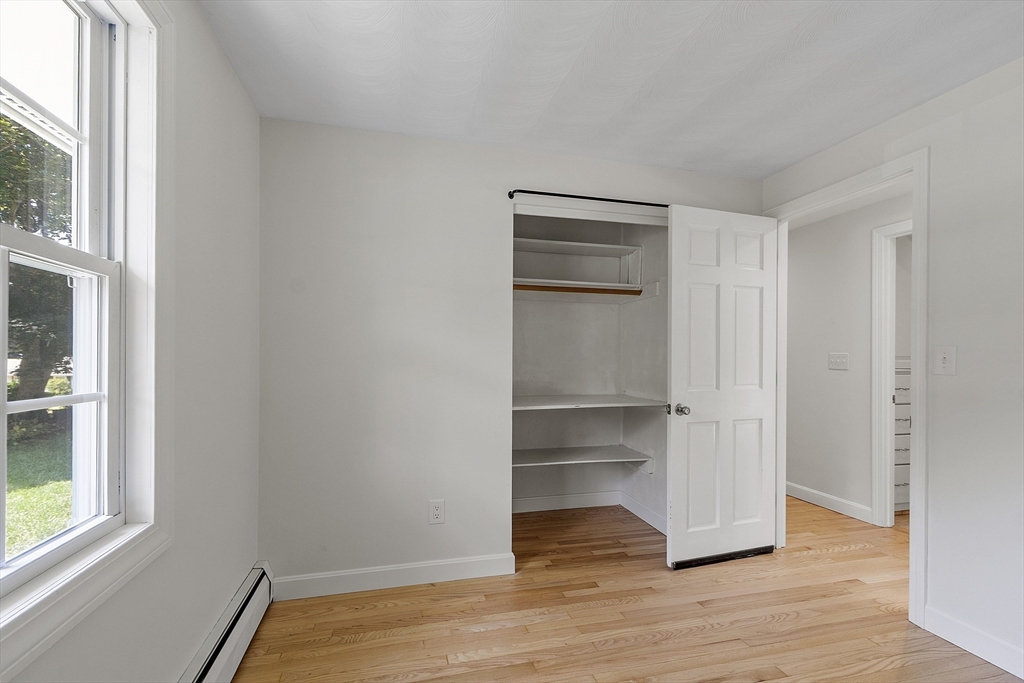 14 Janet Road Chelmsford, MA 01824 - Photo 18 of 36 a view of an empty room and wooden floor and windows