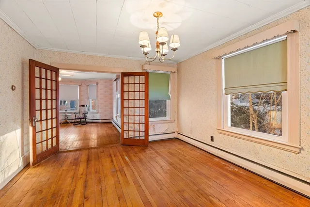 wooden floor in an empty room with a window